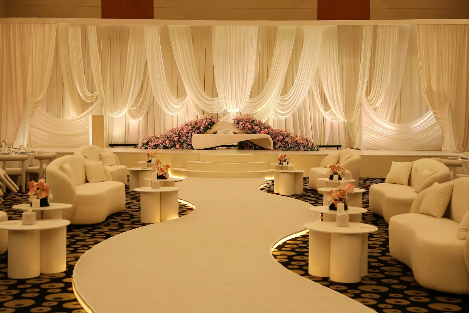 A Monasabat wedding stage lit in gold