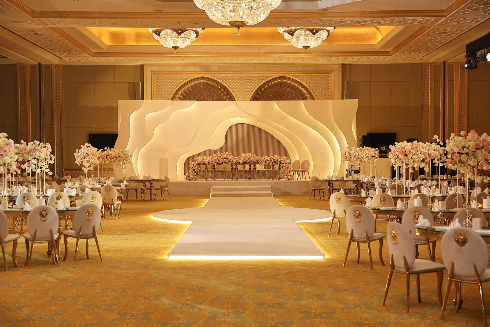 Gold ballroom with a sculpted ivory stage