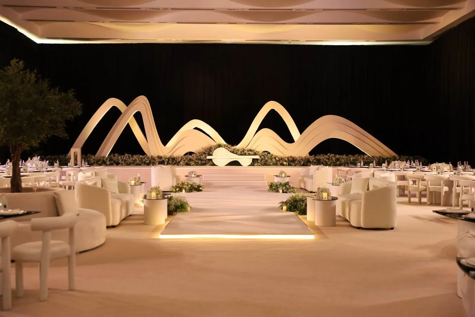 Sculpted wave stage with warm lighting