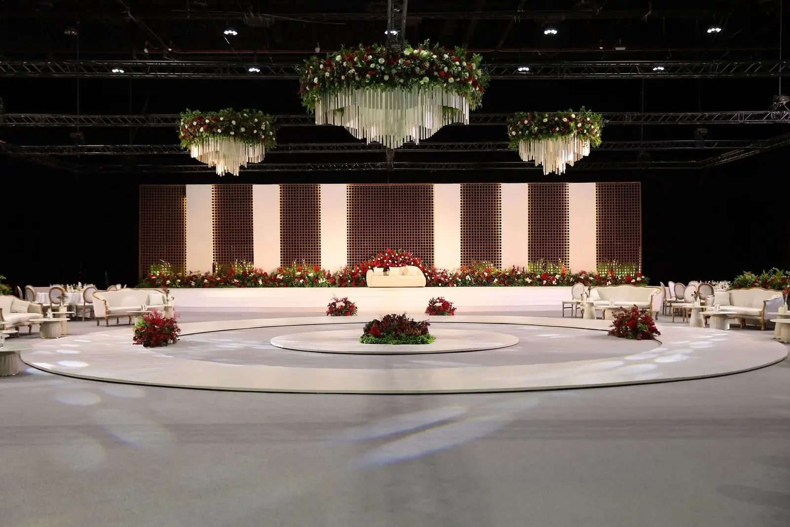 Floral chandeliers over a round stage